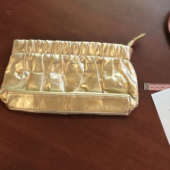 Donna Karen Handbags - Donna Katen, Gold Hand clutch.